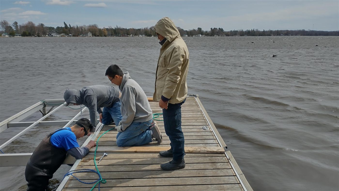 Calvin and friends installing a dock at the retreat