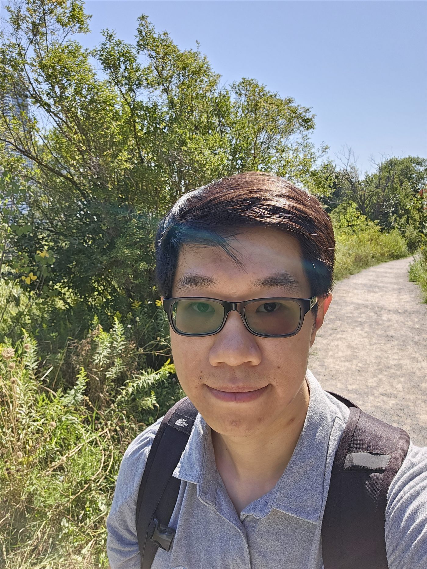 Calvin standing on a hiking trail outdoors
